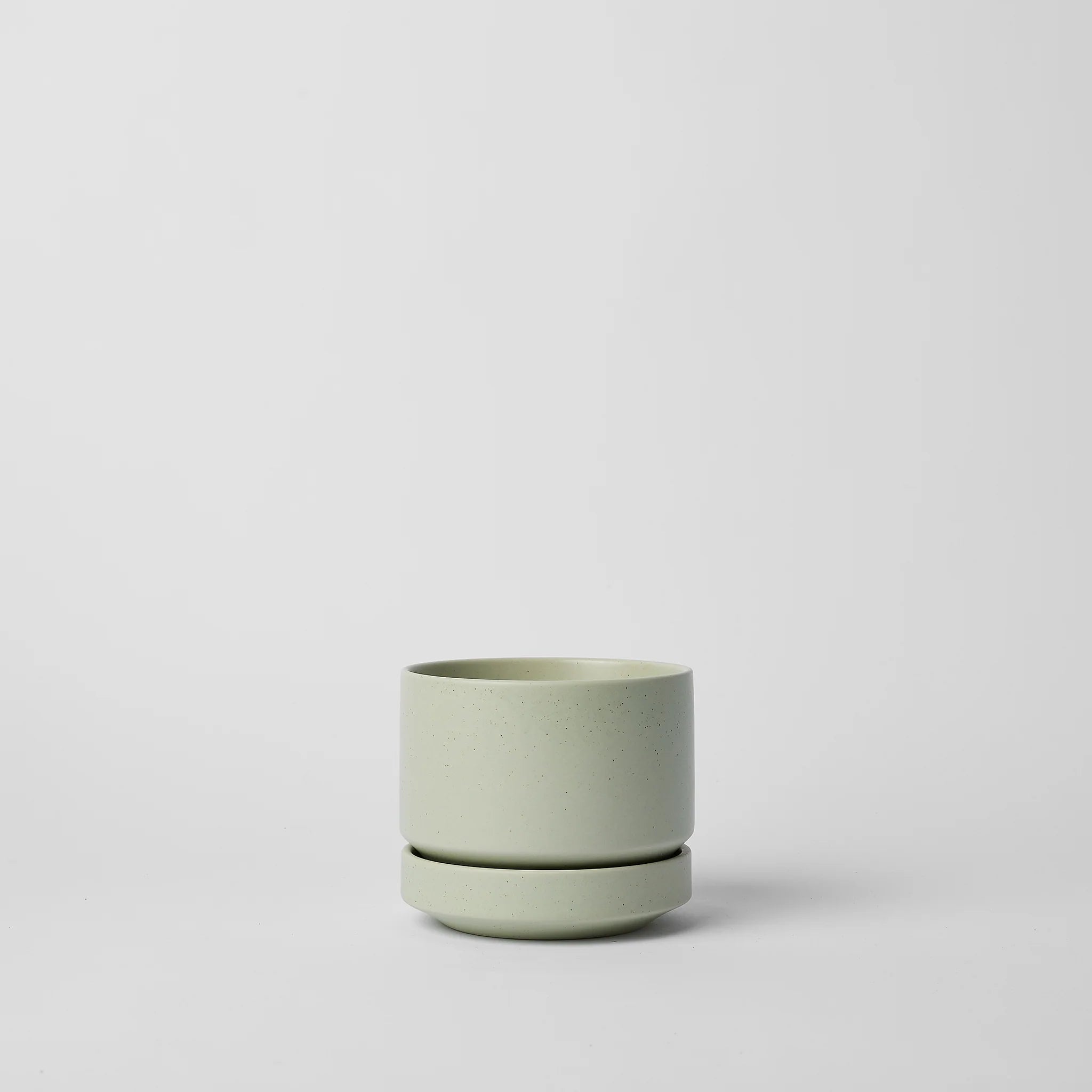 Green ceramic planter on a light gray background