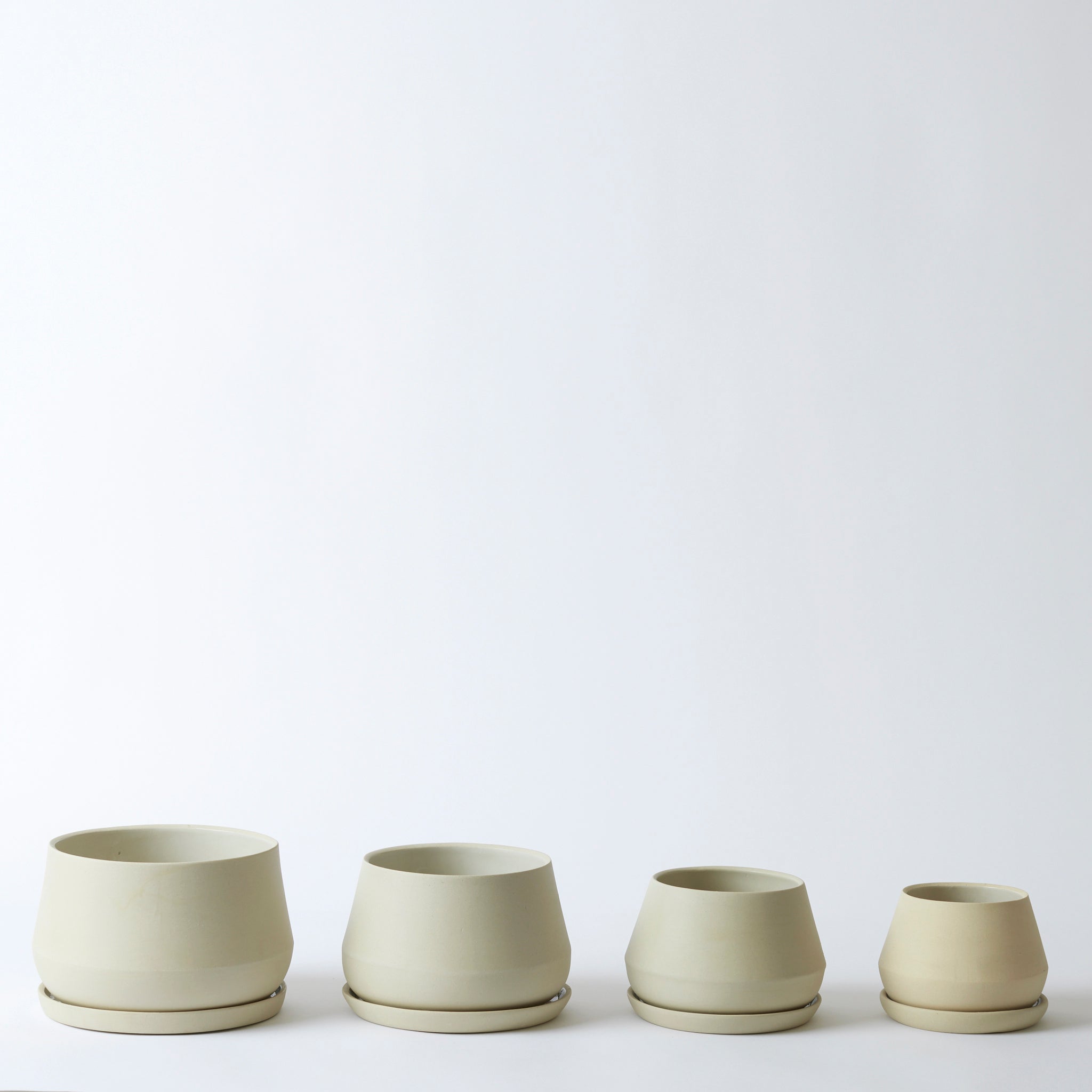 Group image of the sand colored Rancho Planters in various sizes. They are a beautiful off-white, cream color and come with saucers.