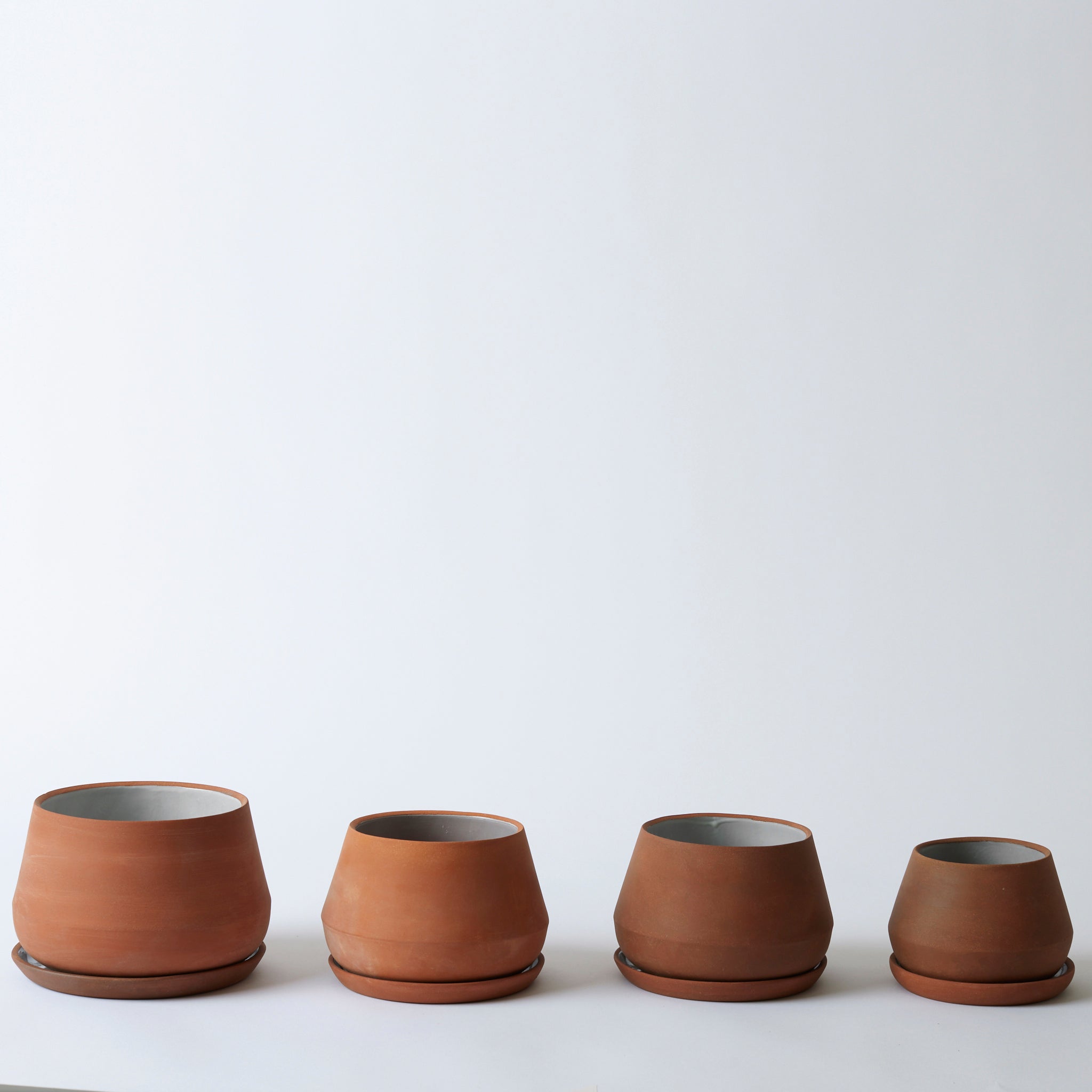 Group image of the various sizes of terra cotta Rancho Planters. They each have a planter tray.