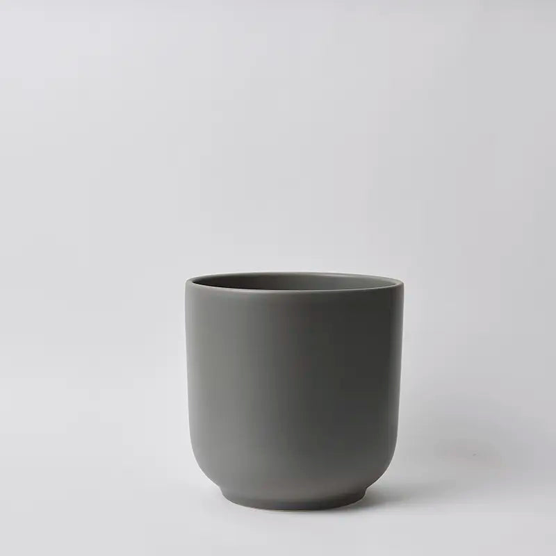 Dark 10 Inch gray ceramic cup on a light gray background