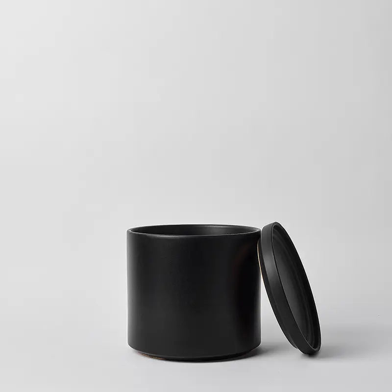 Black 10 Inch cylindrical container with lid on a light gray background