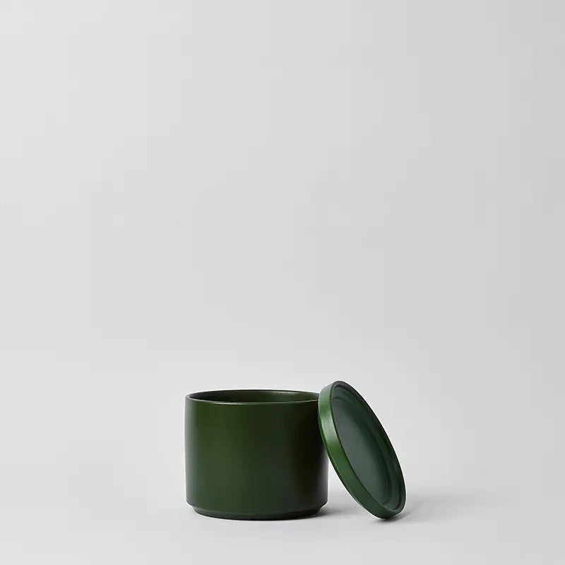 Green 6 Inch ceramic container with lid on a light gray background