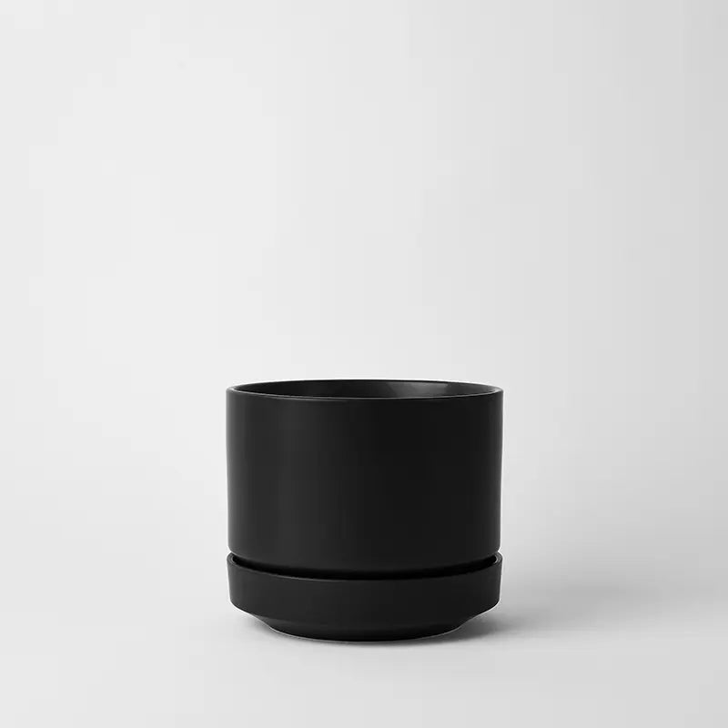 Black 8 inch planter pot on a light gray background
