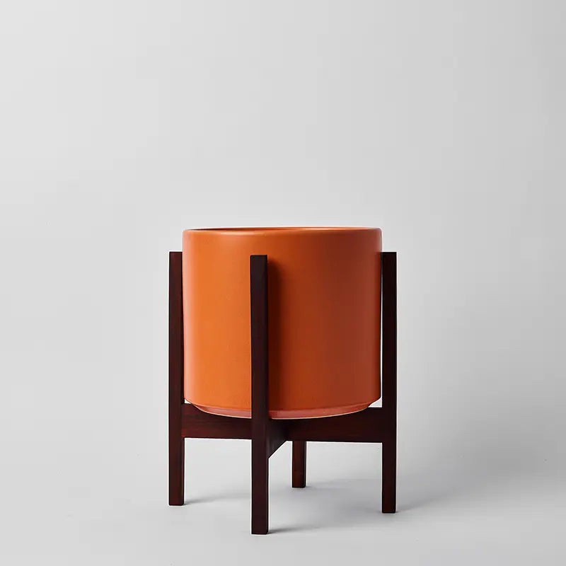 Rust 10 Inch planter on a dark square stand against a light gray background