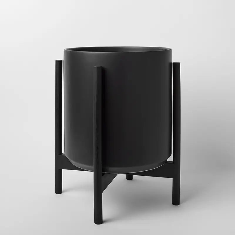 Black 14 Inch cylindrical planter with black rounded stand on a light gray background