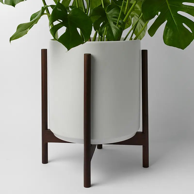 White 14 Inch planter with dark rounded stand on a light gray background