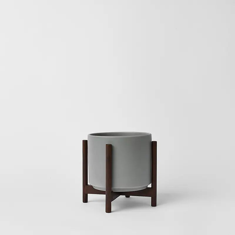 Gray 6 Inch planter with dark rounded stand on a white background