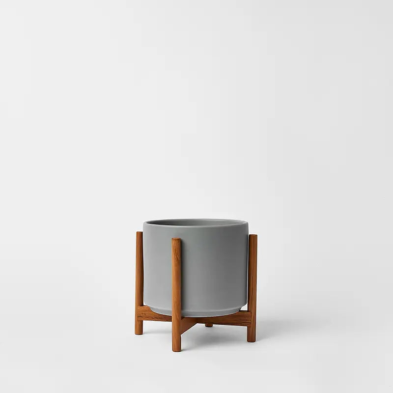 Gray 6 Inch planter with natural rounded stand on a white background
