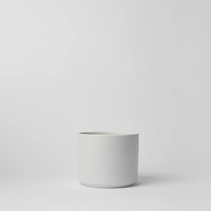 White 6 inch ceramic planter on a light gray background