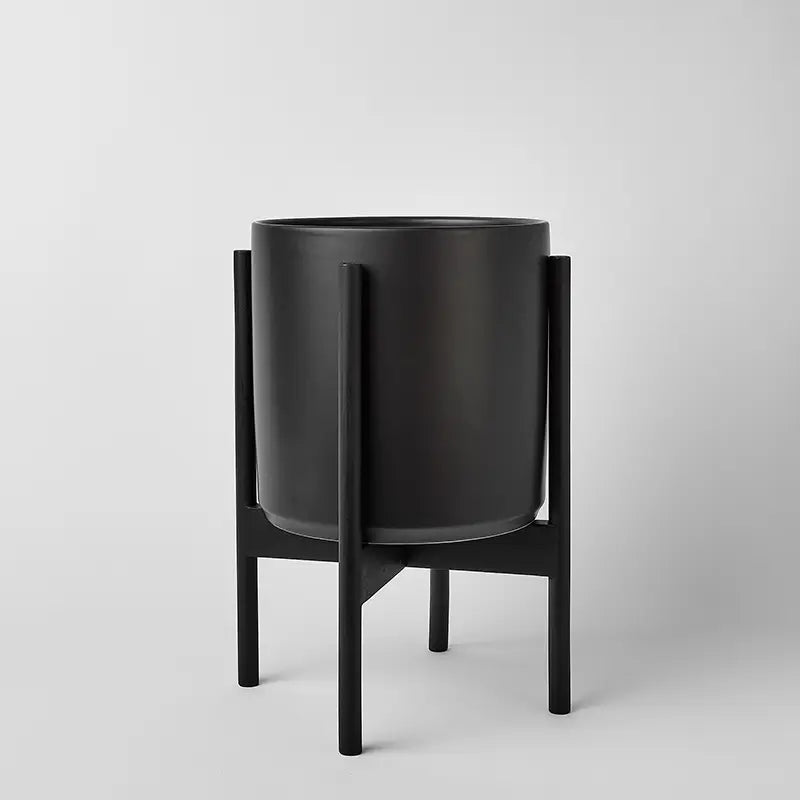 Black 10 Inch planter with black rounded stand on a light gray background