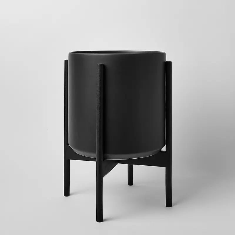 Black 12 Inch planter with black rounded stand on a light gray background