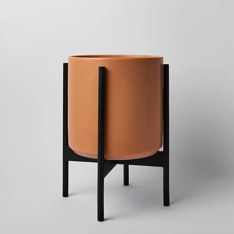 PeachyCotta 12 Inch Cylindrical pot on a black rounded stand against a light gray background