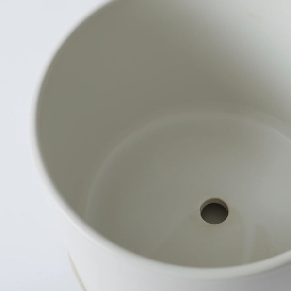 Close-up of a beige ceramic sink basin on a white background