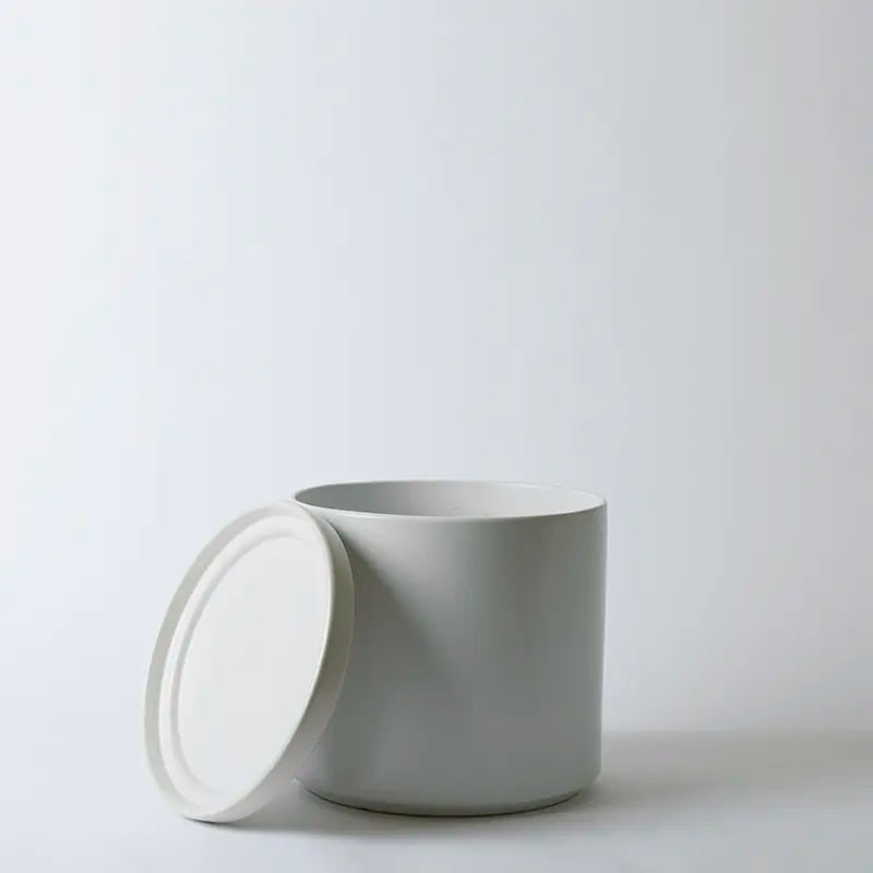 White 12 Inch ceramic pot with a lid on a light gray background