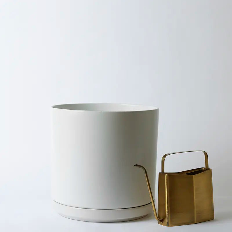 White 15 Inch planter and gold watering can on a light gray background