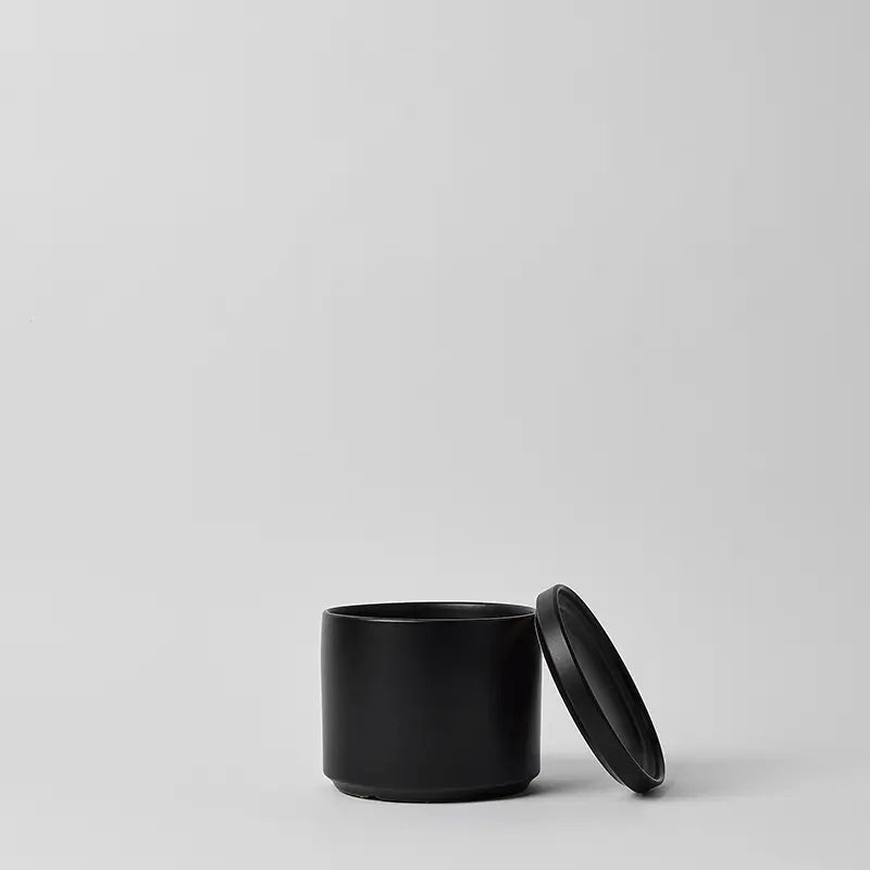 Black 6 Inch ceramic container with lid on a light gray background