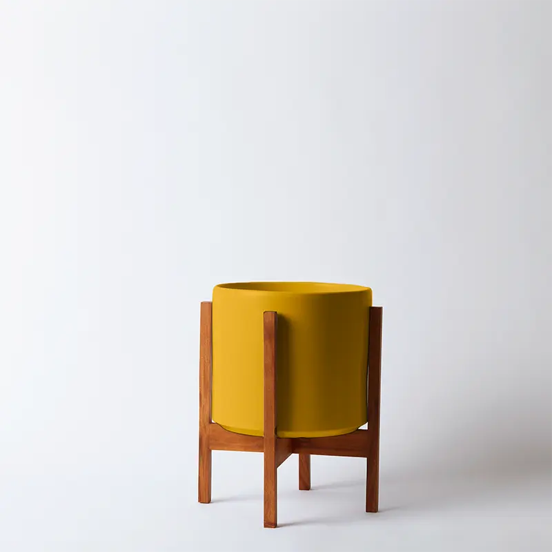 Mustard 10 Inch planter with light square stand on a white background