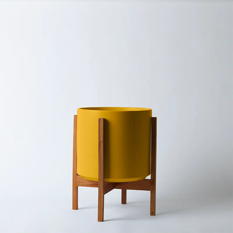 Mustard planter with light square stand on a light gray background