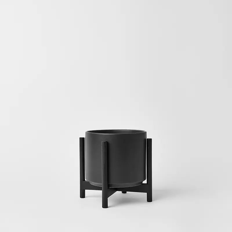 Black 6 Inch planter with bliack rounded stand on a white background