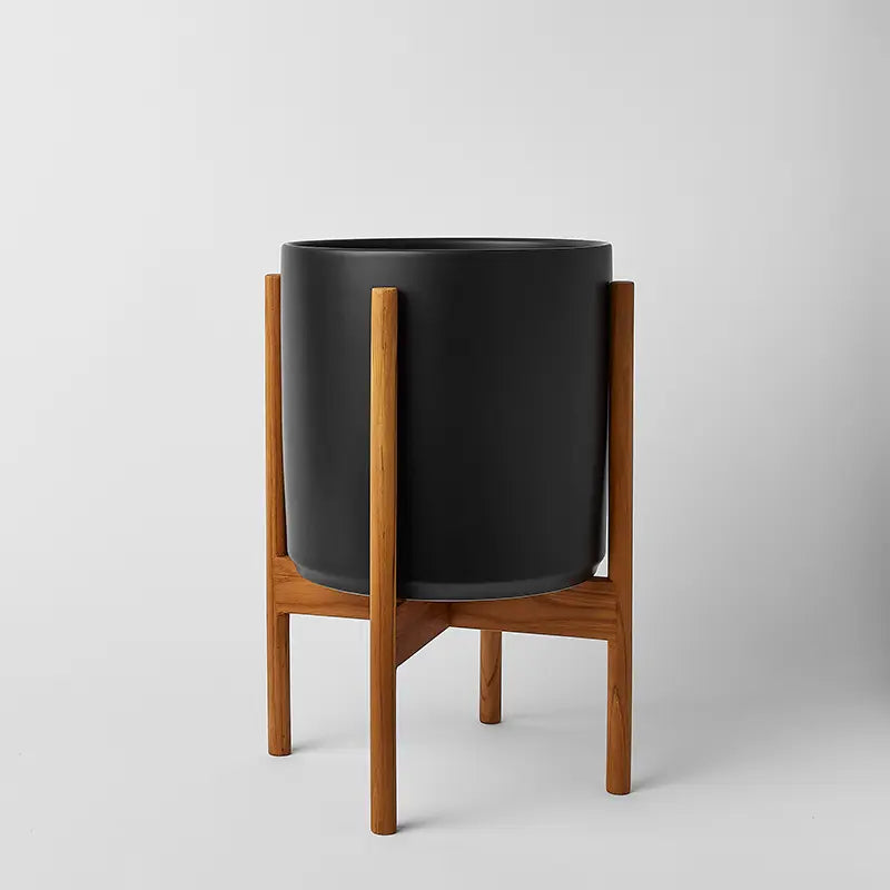 Black 10 Inch planter on a light rounded stand against a natural gray background