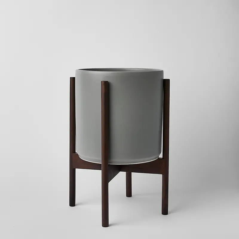 Gray 10 Inch planter with dark rounded stand on a light gray background