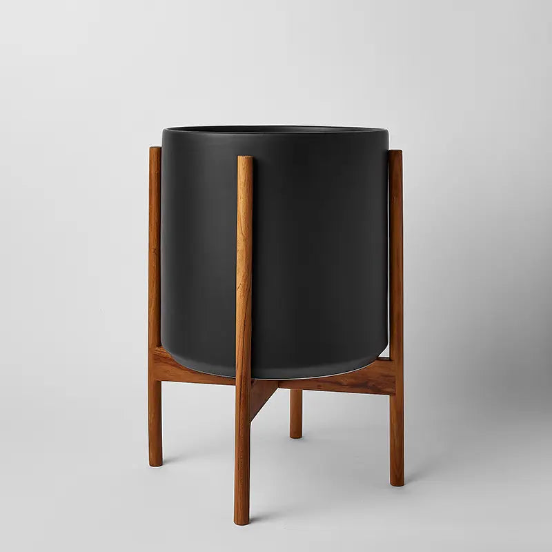Black 12 Inch planter on a natural rounded stand against a gray background