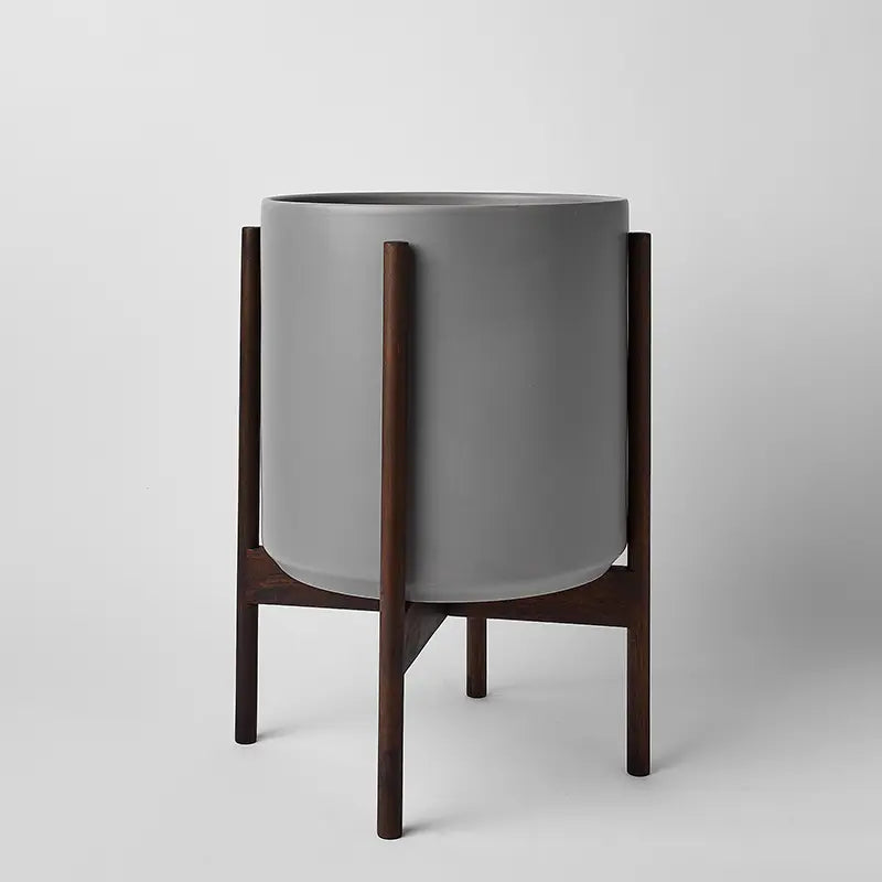 Gray 12 Inch planter with dark rounded stand on a light gray background