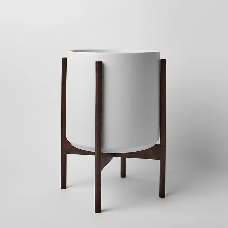 White 12 Inch planter with dark rounded stand on a light gray background